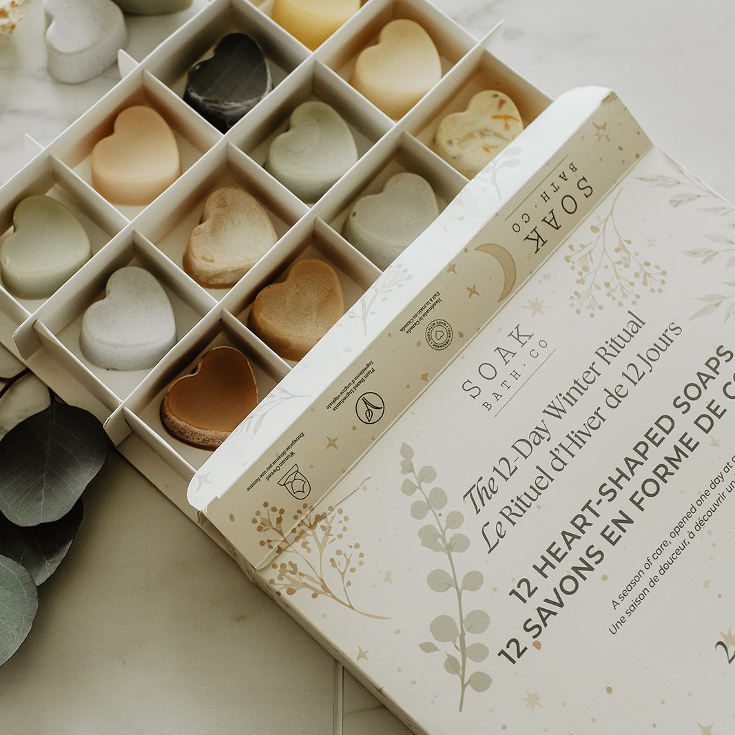 Heart-shaped soaps in a decorative box on a marble surface