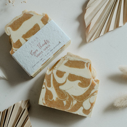 Marbled Give thanks soap bar with a decorative box on a light surface with dried plants.