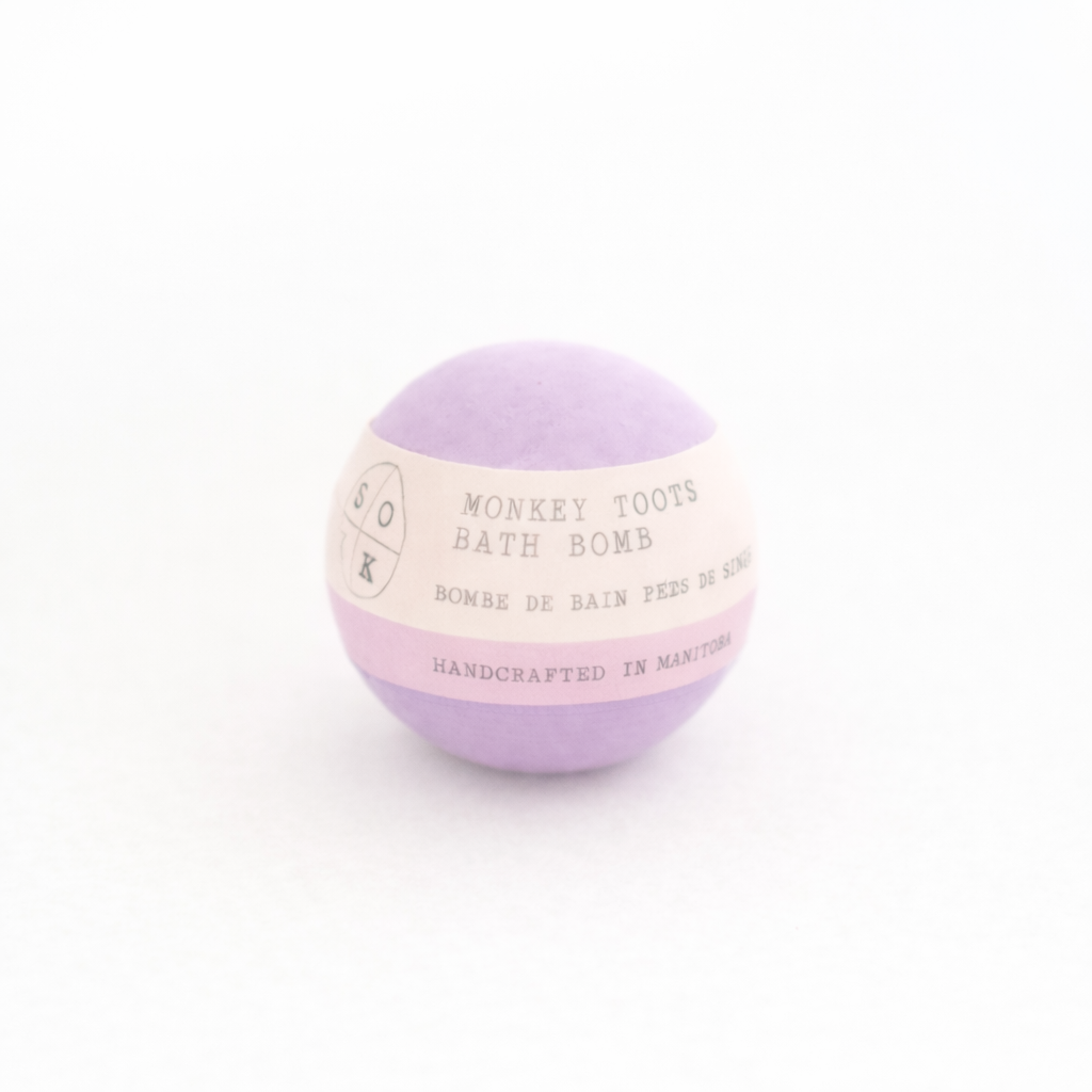 Purple bath bomb with a label on a white background