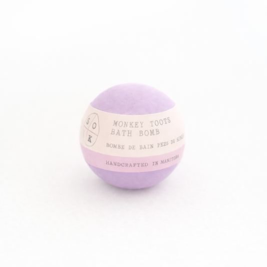 Purple bath bomb with a label on a white background