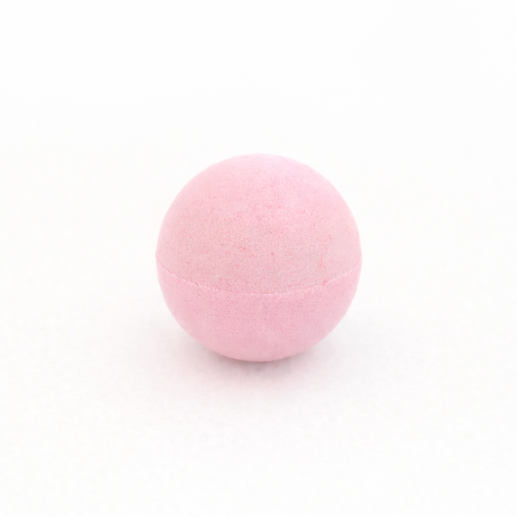 Pink bath bomb on a white background